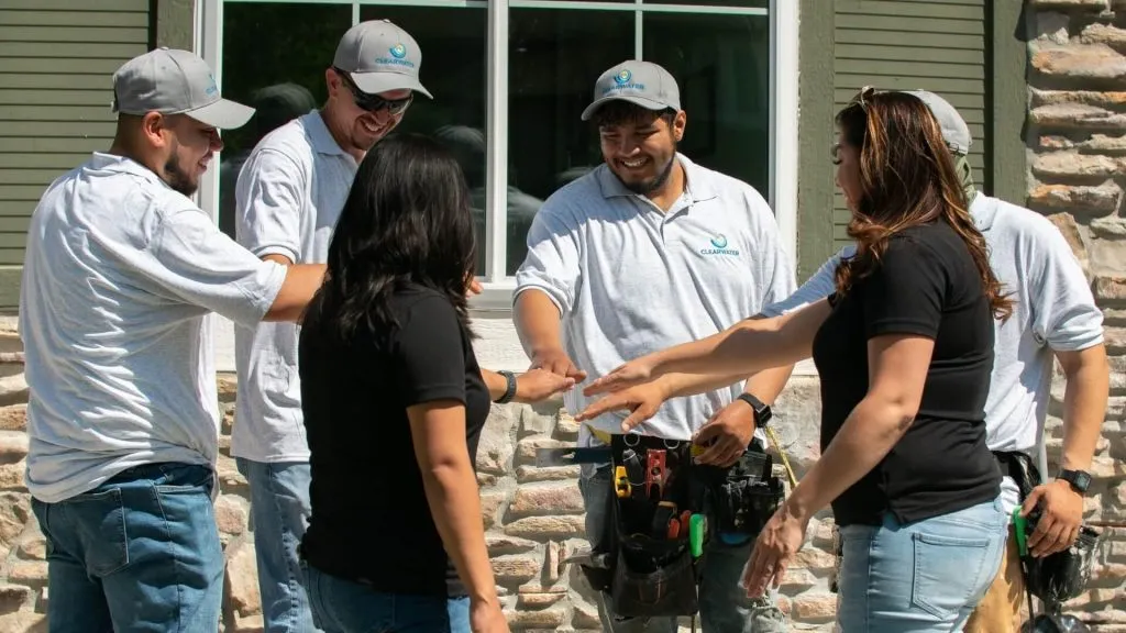 The team at Clearwater Exteriors in a huddle installing replacement windows in Denver CO